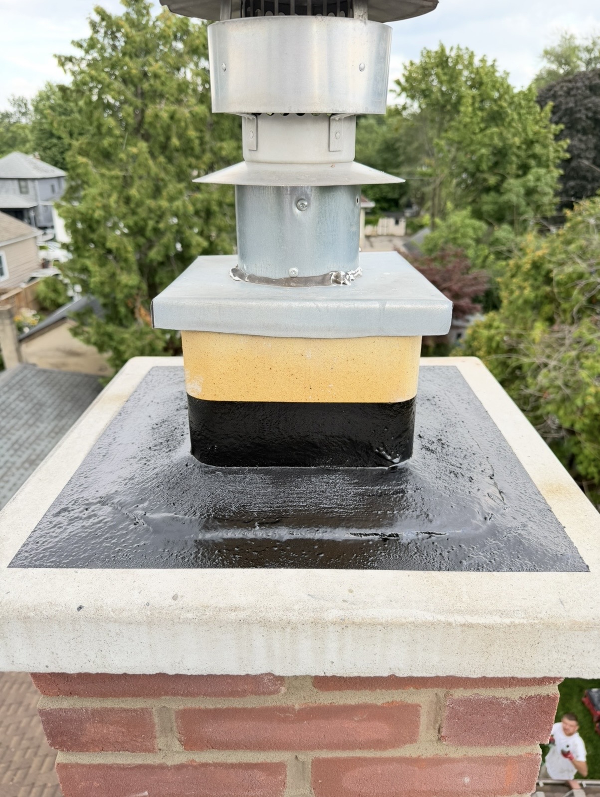 Chimney Crown & Flue Sealing — Chimney crown sealed around the flue liner and metal cap.