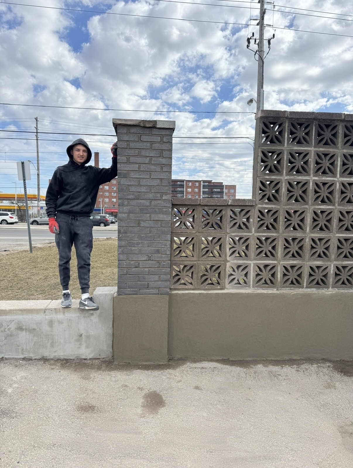 Freshly parged block wall with a new brick pillar