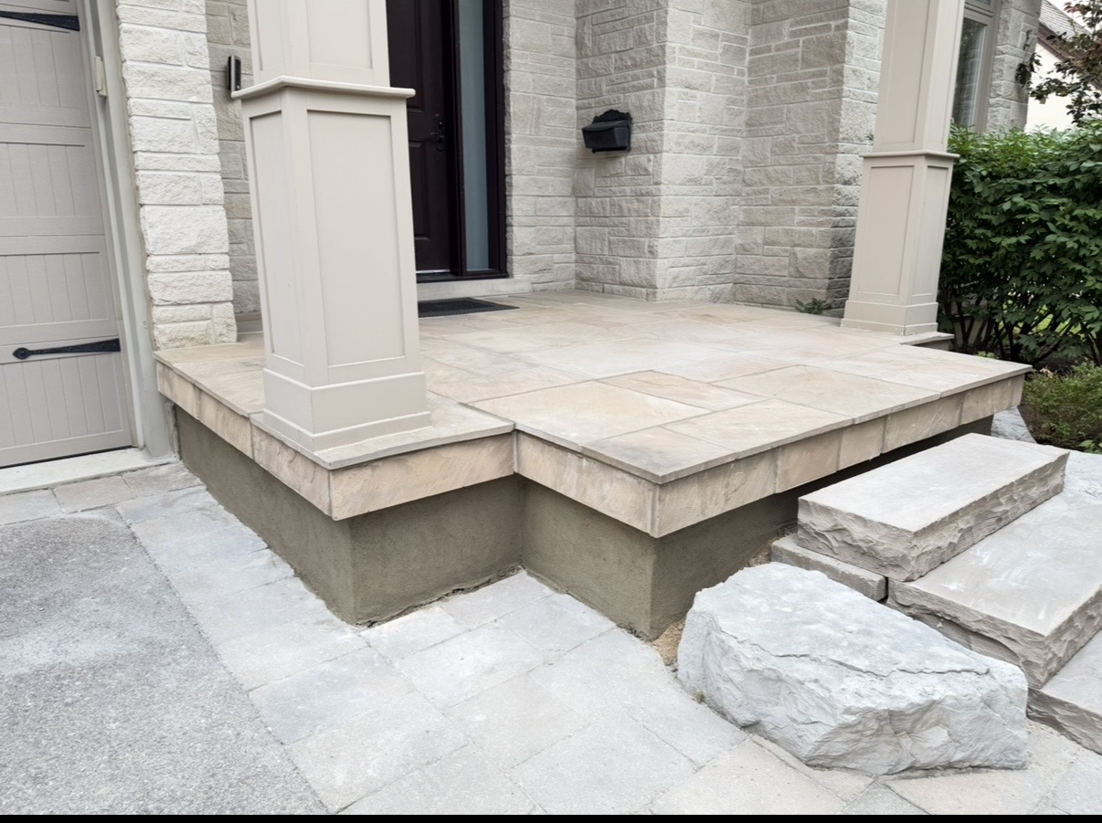 Flagstone porch with capped edges and natural stone steps