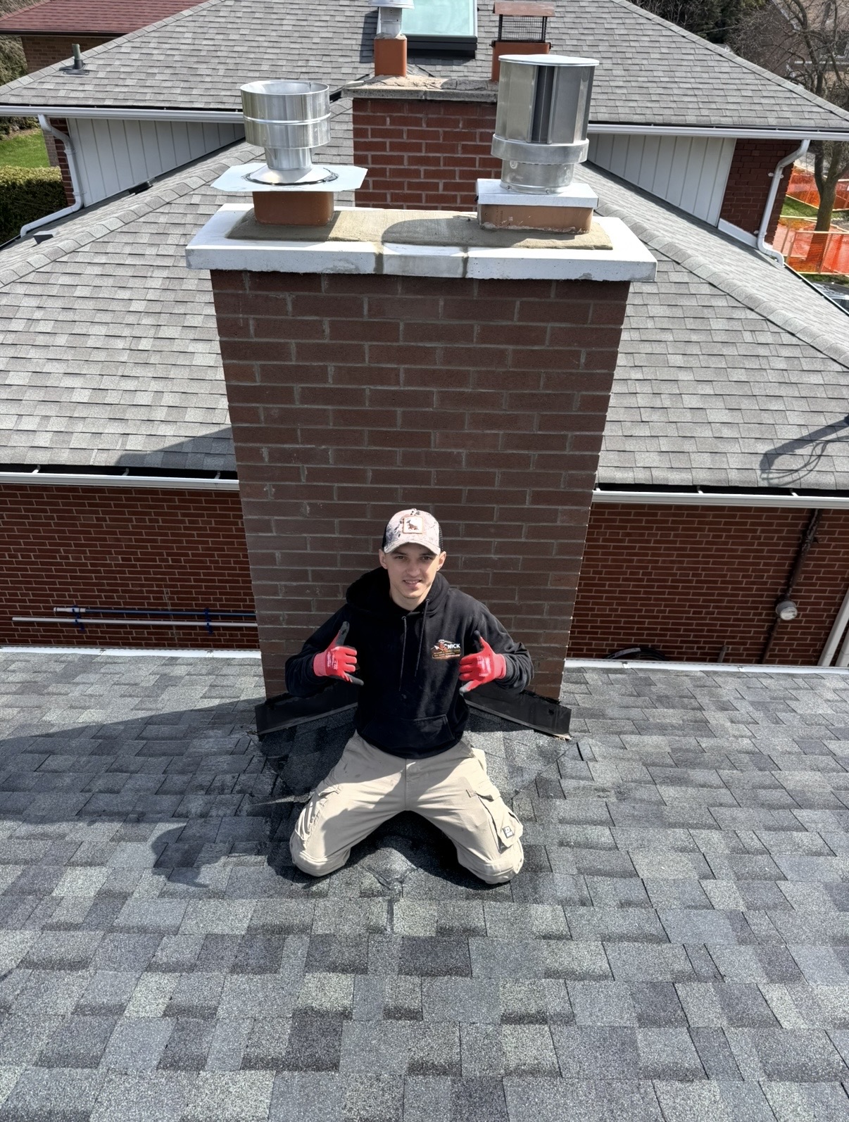 Chimney & Crown Work — Brick chimney with a finished crown and two stainless flue caps.
